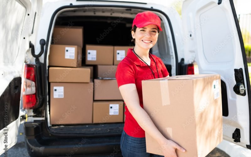 Female courier and driver carrying a bunch of packages